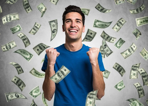 Portrait of a very happy young man in a rain of money